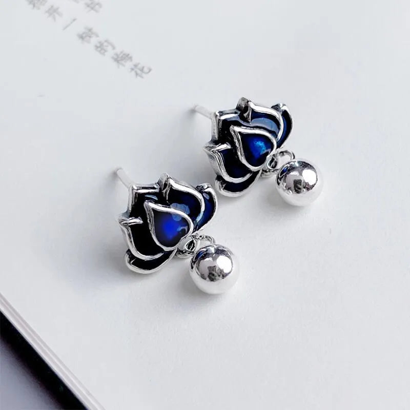 Blue lotus flower alloy earrings with seedpod and tassel design, silver plated, shown at actual size of 1.2cm wide.