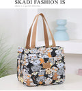 Women's printed canvas handbag with aluminium handle showing floral and animal design options