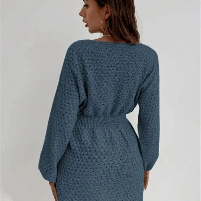 Blue women's knitted dress with French neckline, fitted waist, and hand-crocheted flower detailing