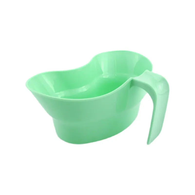 Green plastic gargle cup for bedridden patient oral care on bedside table