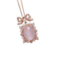 Geometric silver alloy pendant with pink rose quartz crystal and rose gold plating on a chain.