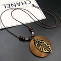 Wooden leaf pendant necklace with ethnic design featuring cotton and linen materials on wax line chain