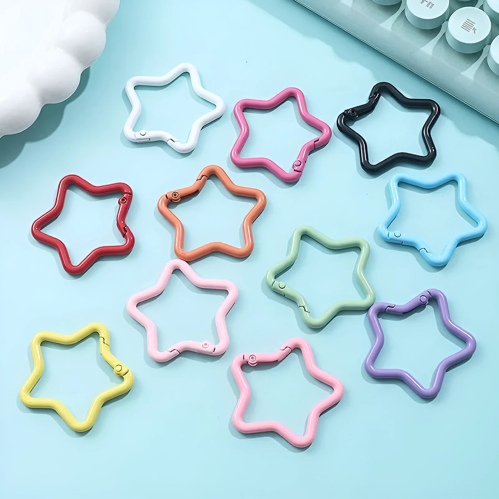 Zinc alloy five-pointed star keychain charm in multiple colour options on a keyring.
