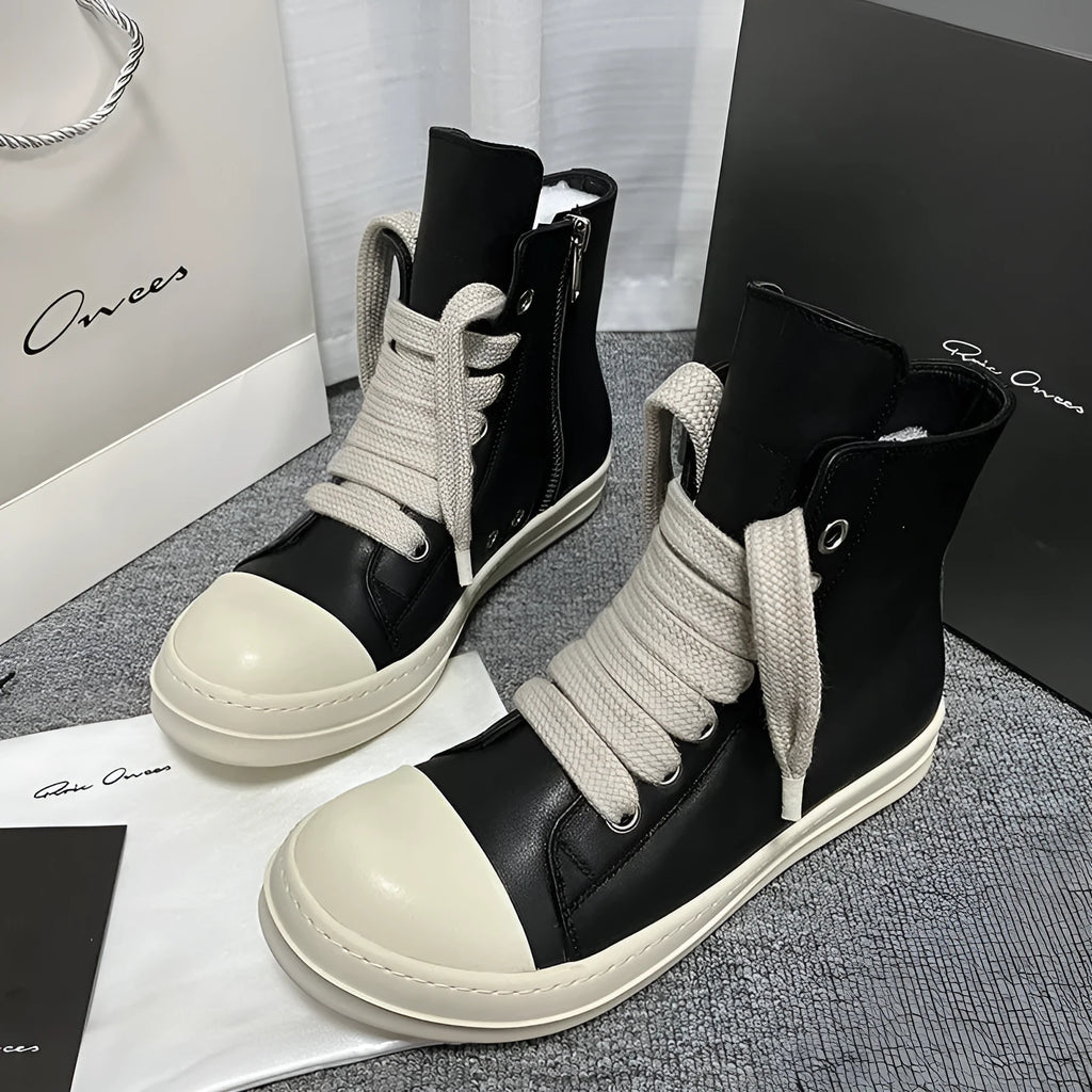 Genuine leather high-top unisex sneakers with side zipper in black, shown on a neutral background.