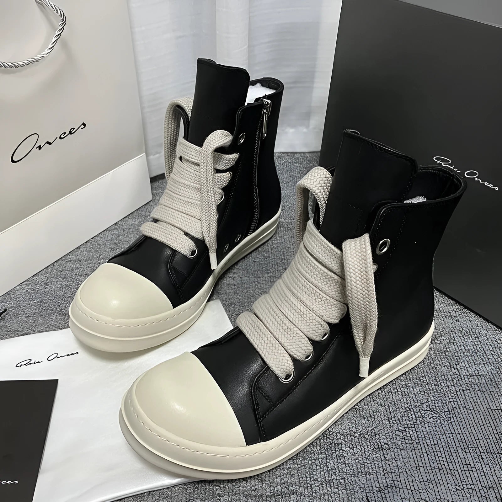 Genuine leather high-top unisex sneakers with side zipper in black, shown on a neutral background.