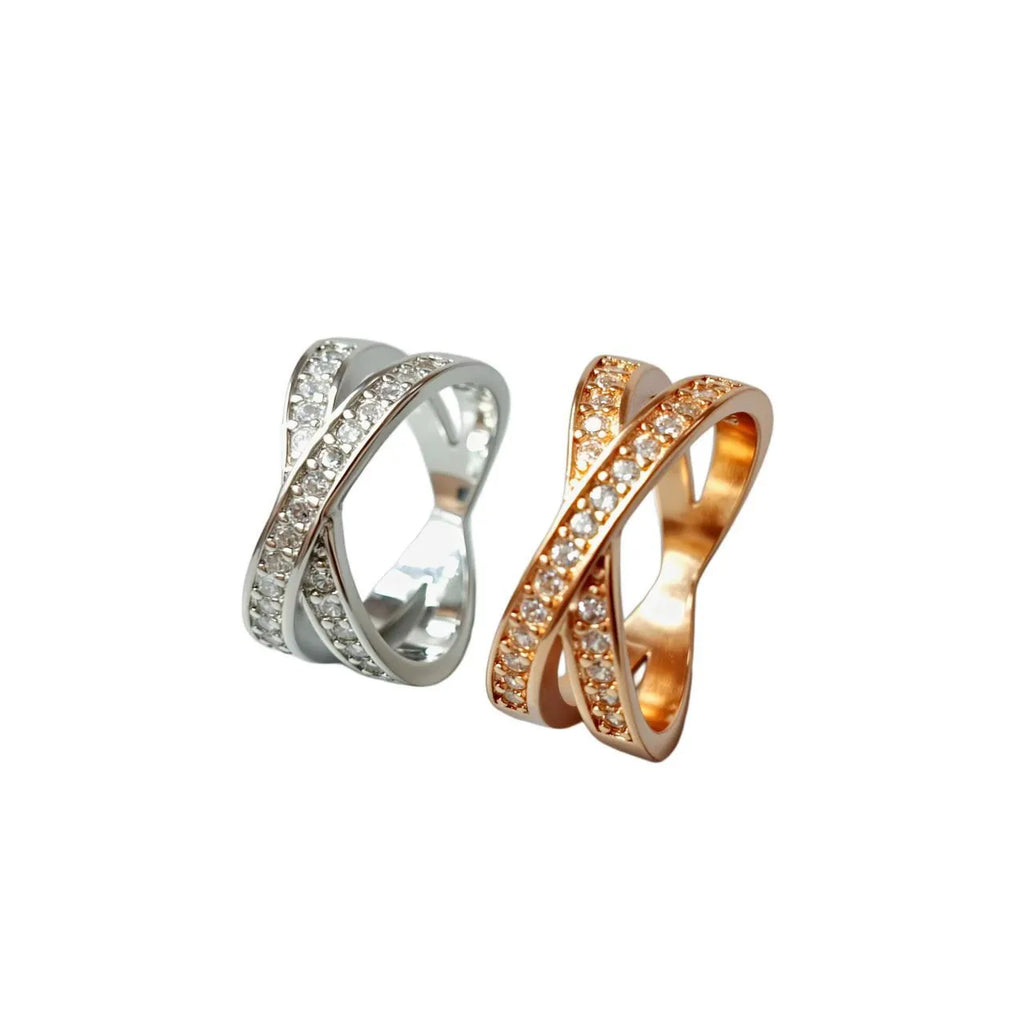 Copper metal cross ring with micro-inlaid zircon stones in silver electroplated finish showing geometric heart-shaped design