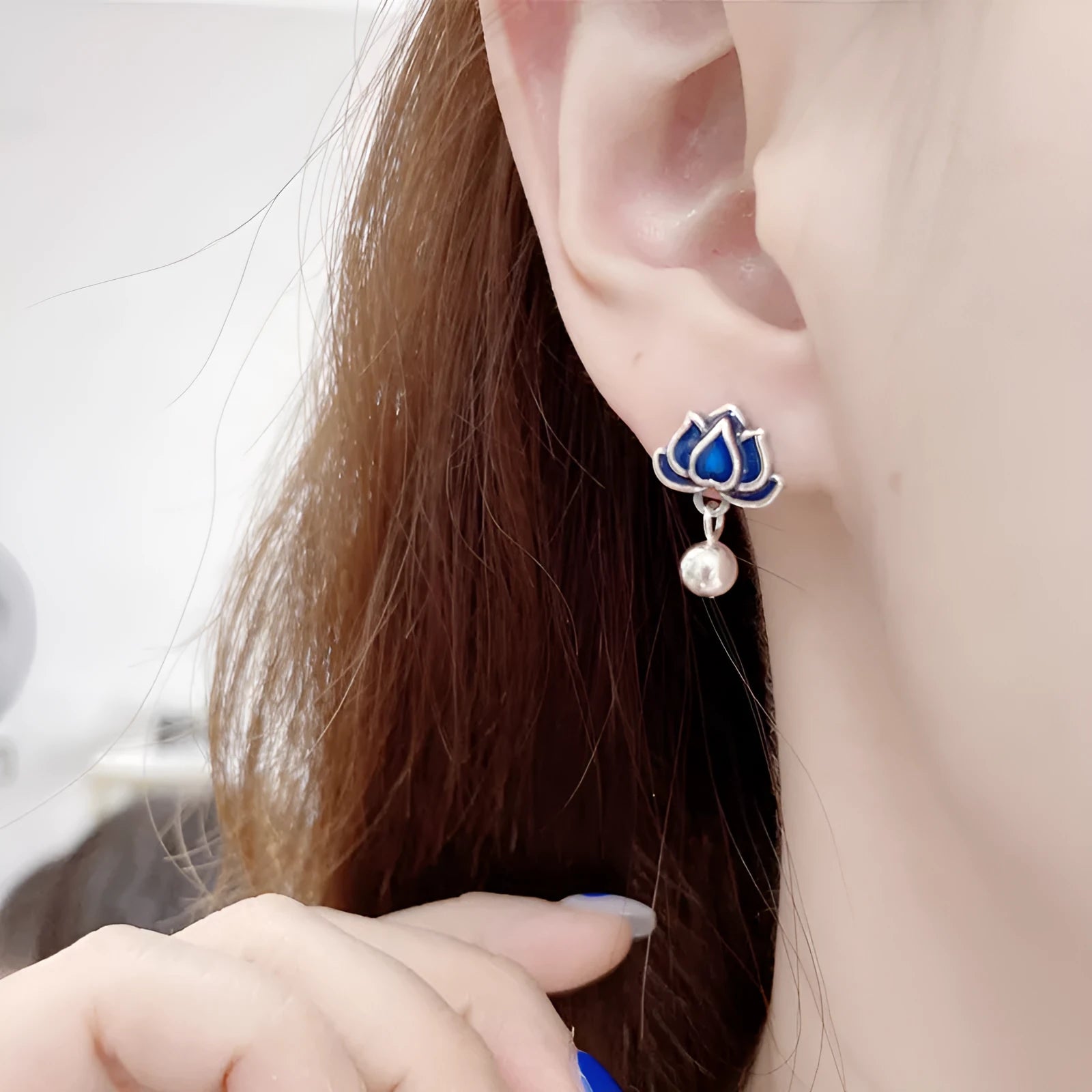 Blue lotus flower alloy earrings with seedpod and tassel design, silver plated, shown at actual size of 1.2cm wide.