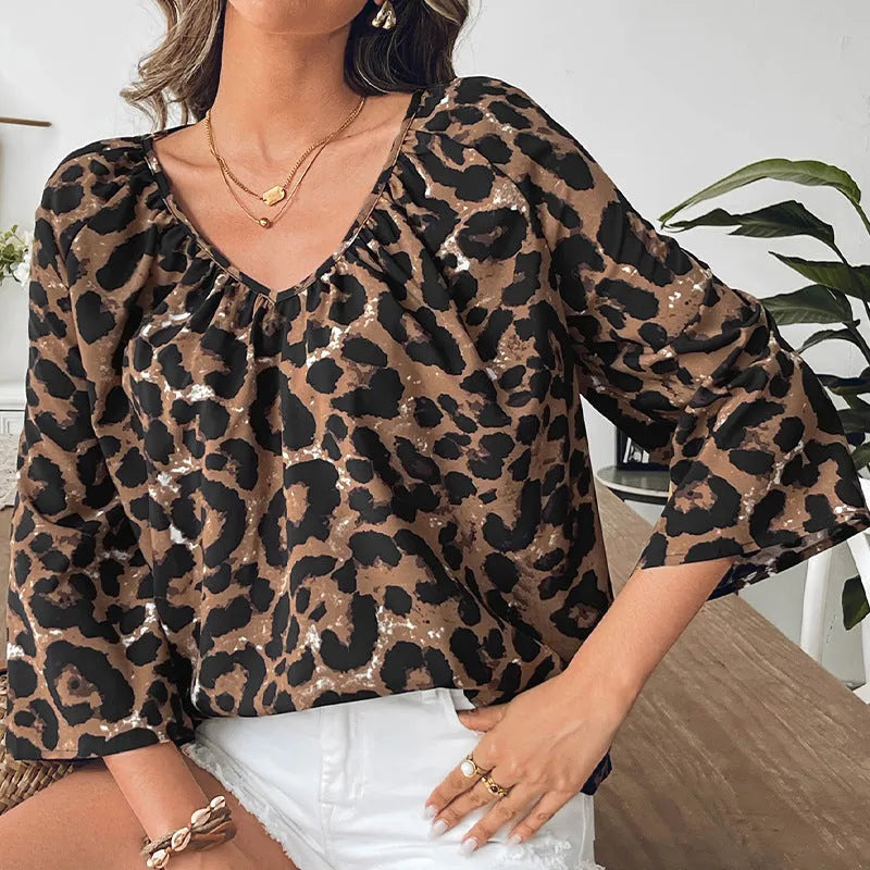 Women's multicolour leopard print polyester pullover top with V-neck and half sleeves.