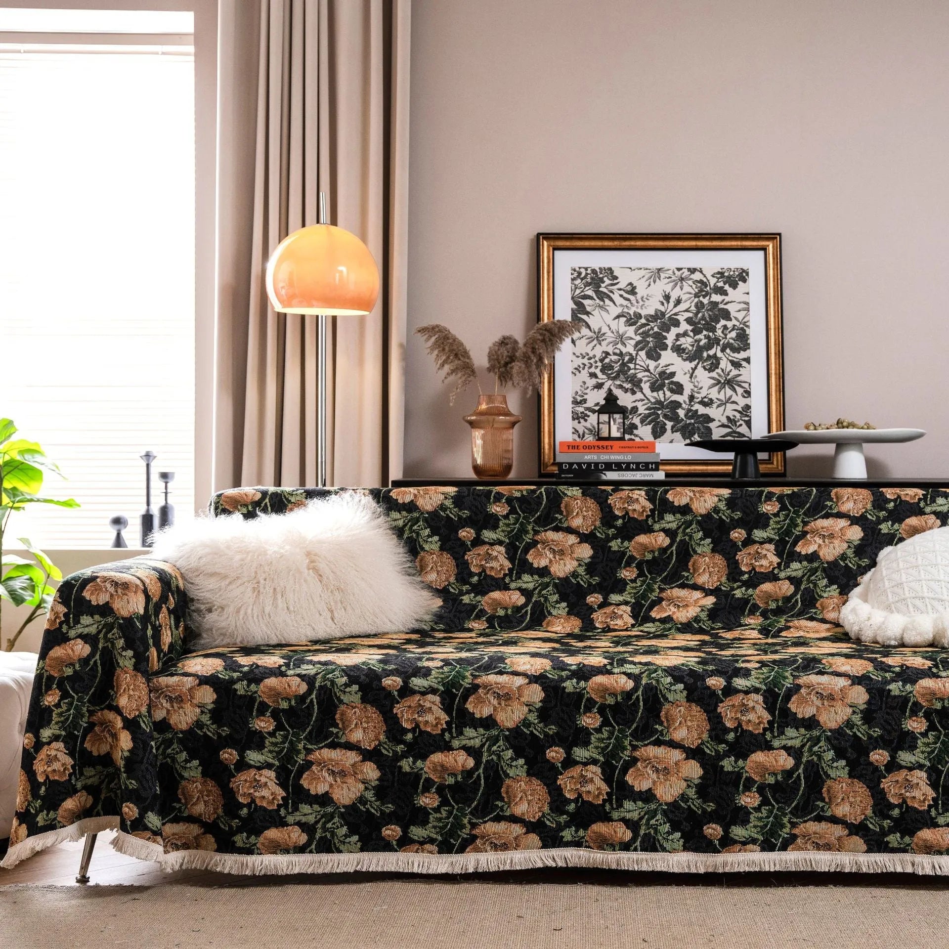 American country style jacquard patterned sofa cover in a green colourway draped over a sofa.