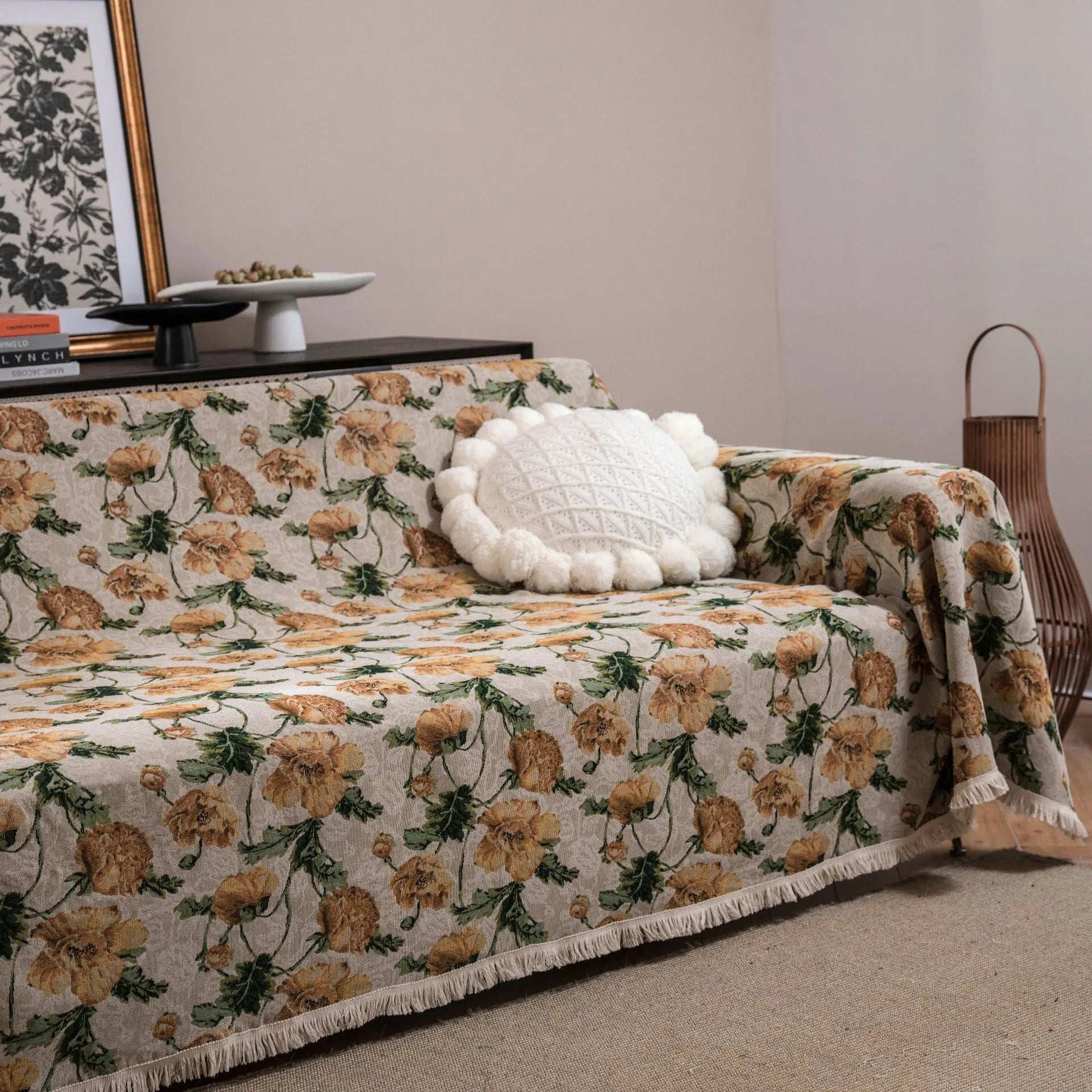 American country style jacquard patterned sofa cover in a green colourway draped over a sofa.
