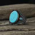 Men's antique silver alloy ring with a round band and a central turquoise-coloured stone.