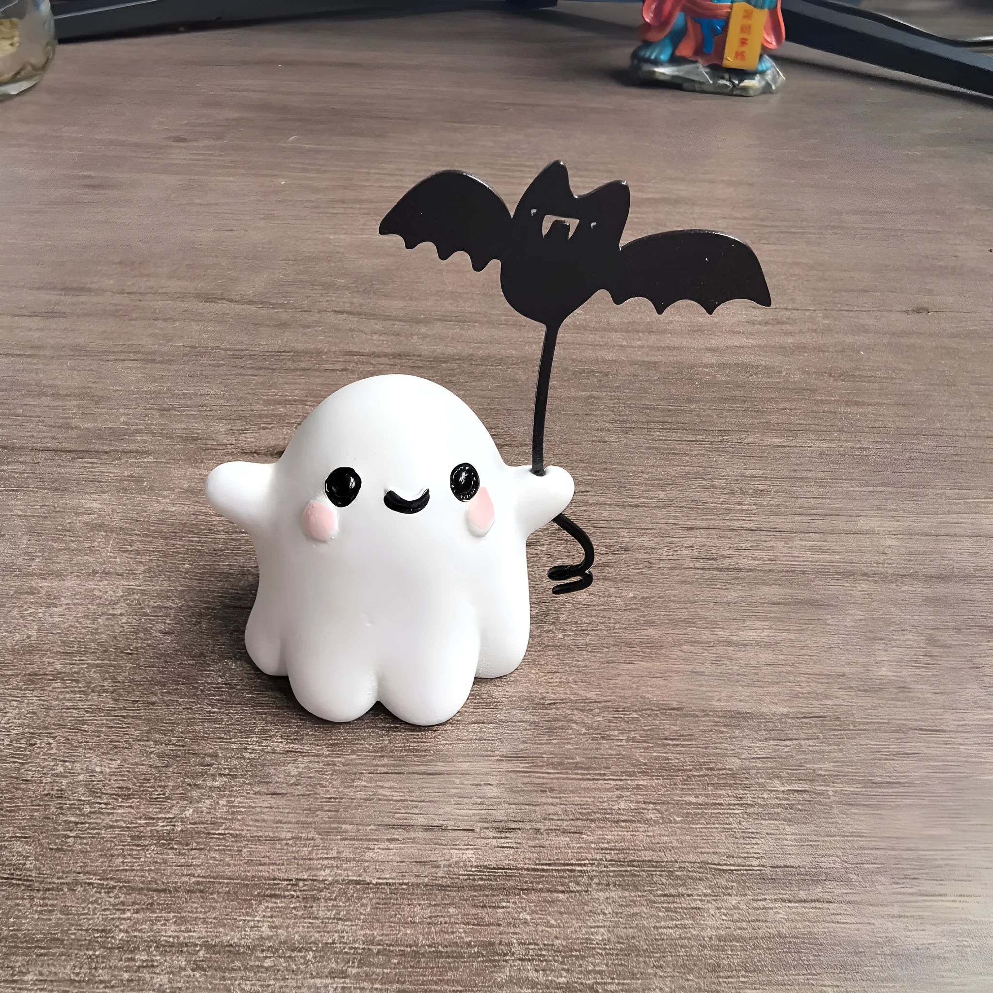 Miniature resin statue of a ghost walking a dog, Halloween decoration measuring 4x5x4cm.