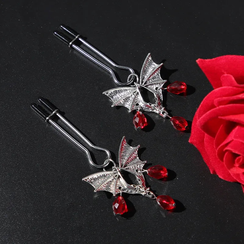 Silver alloy Diamond Bat Nipple Clamp with adjustable screw and ruby bat clip on a white background