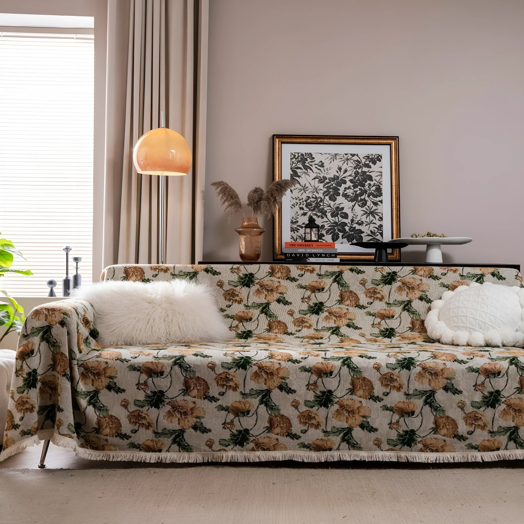 American country style jacquard patterned sofa cover in a green colourway draped over a sofa.