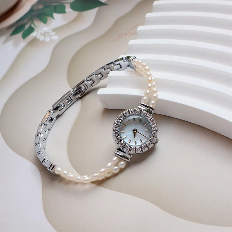 Women's light gold bracelet watch with freshwater pearls, round dial and stainless steel strap