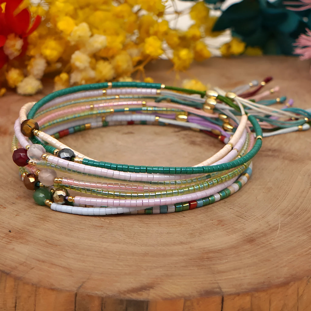 Handmade colourful glass beaded bracelet in geometric Bohemian style on a female wrist.
