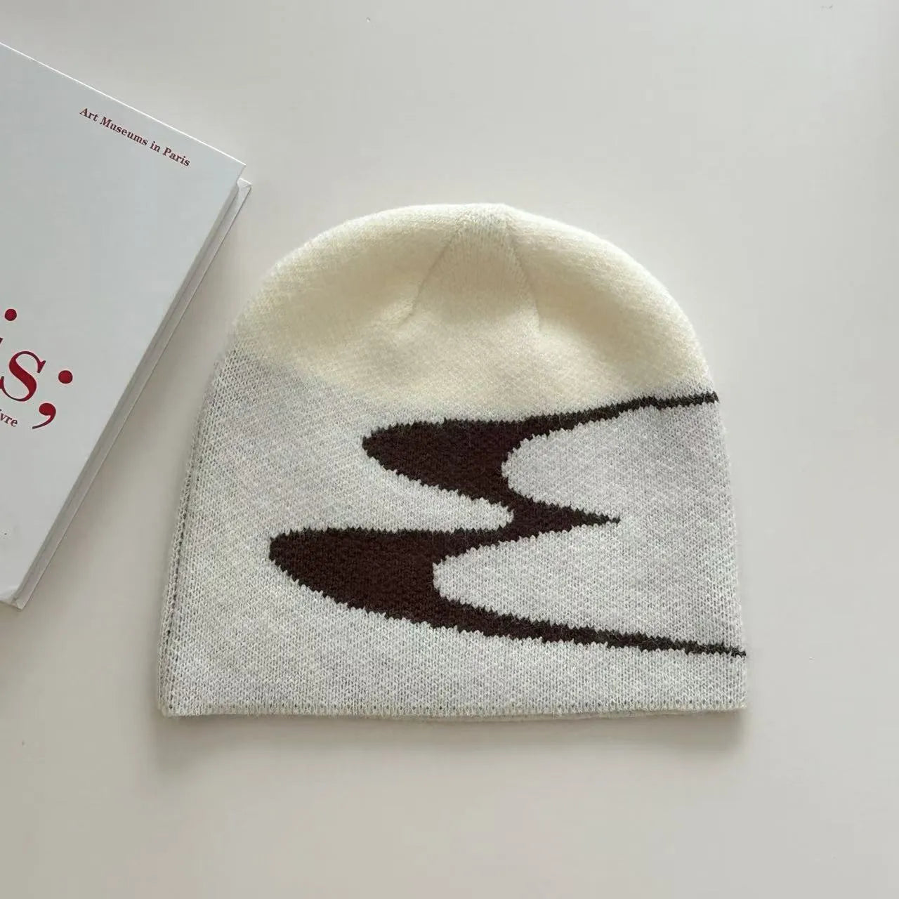 Acrylic knitted beanie hat in black colour showing thermal winter cap design
