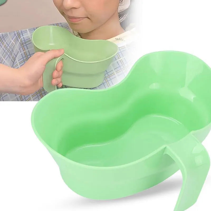 Green plastic gargle cup for bedridden patient oral care on bedside table