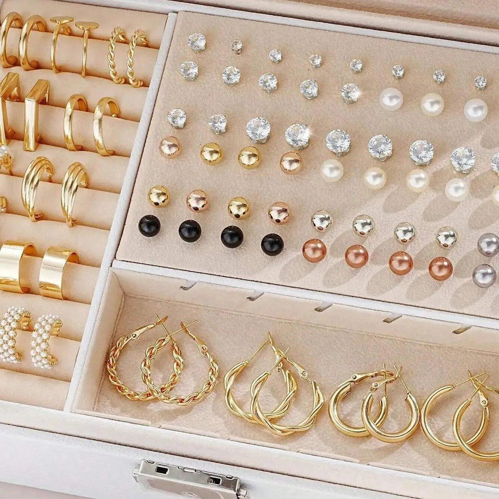 108 gold and yellow geometric round pearl earrings spread out, showing electroplated alloy construction.