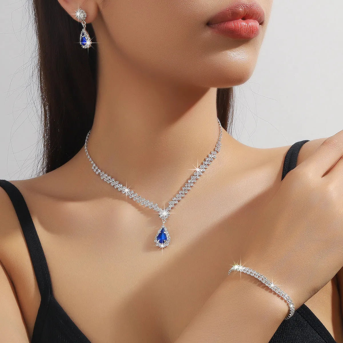 Rhinestone claw chain necklace and earrings set with water drop shape, available in multiple colours for women.