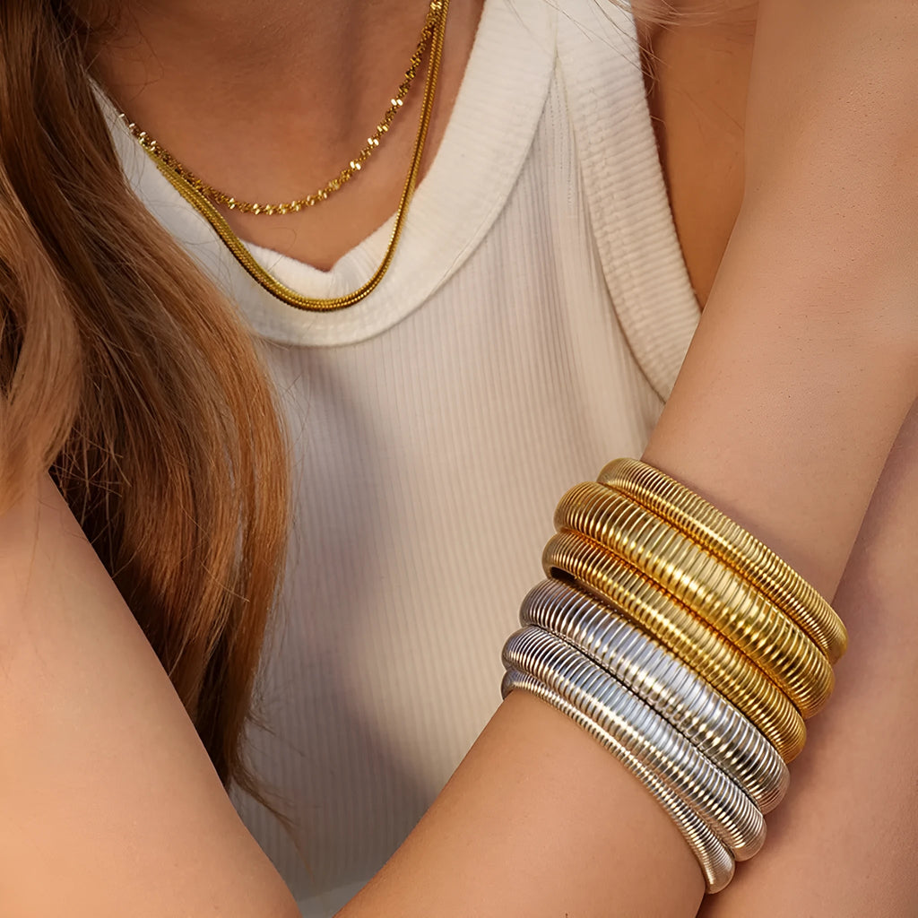 Women's titanium steel bracelet with vertical stripes in gold finish, elastic ring design