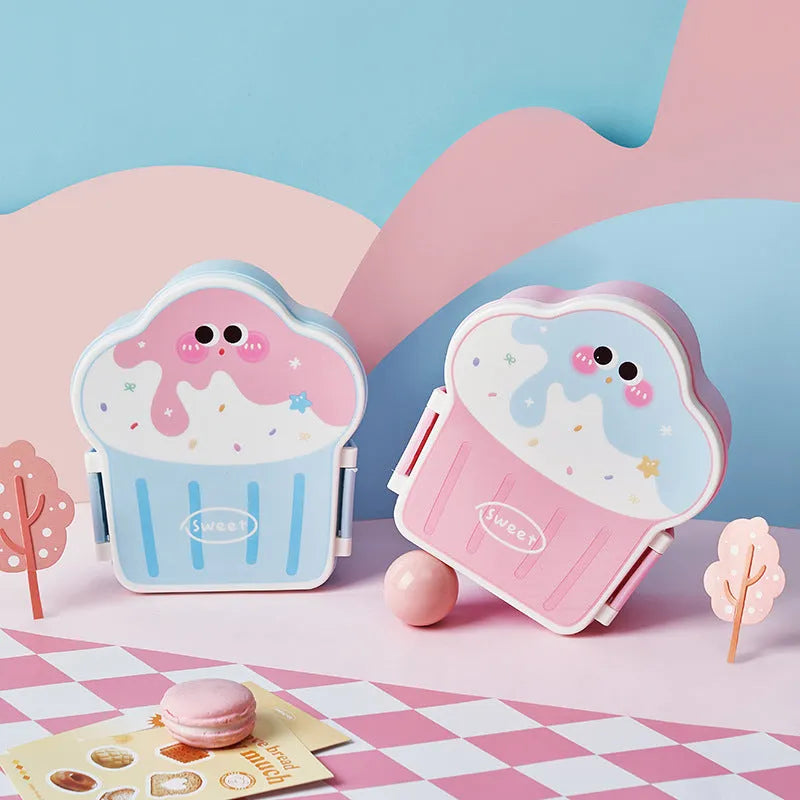 Pink and blue creative ice cream shaped plastic lunch box with spoon and fork set on a table.