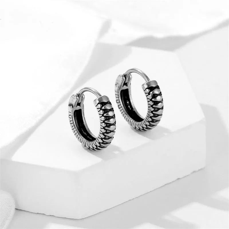 Silver titanium steel retro earrings with a geometric twist and striped design.