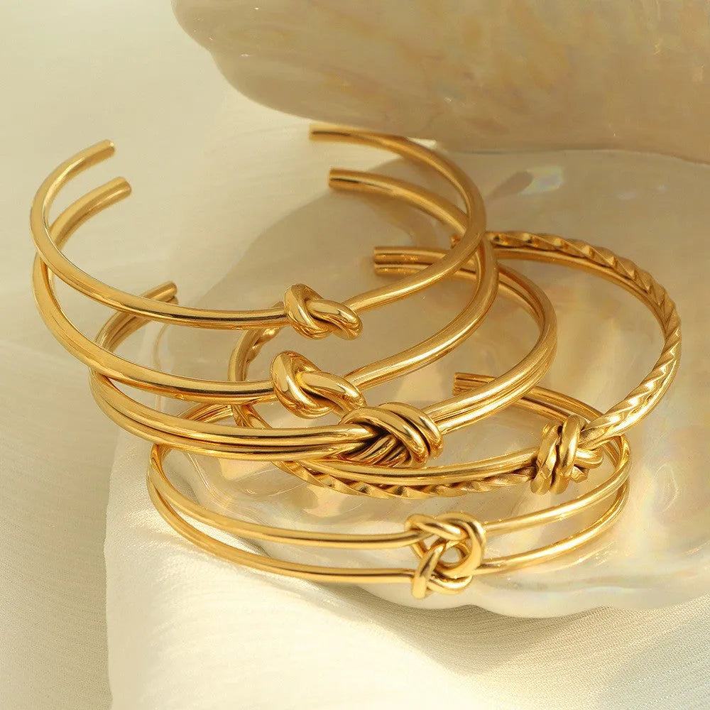 Stainless steel 18K gold plated knotted open double-layer bracelet in gold (SZ46G) on a white background
