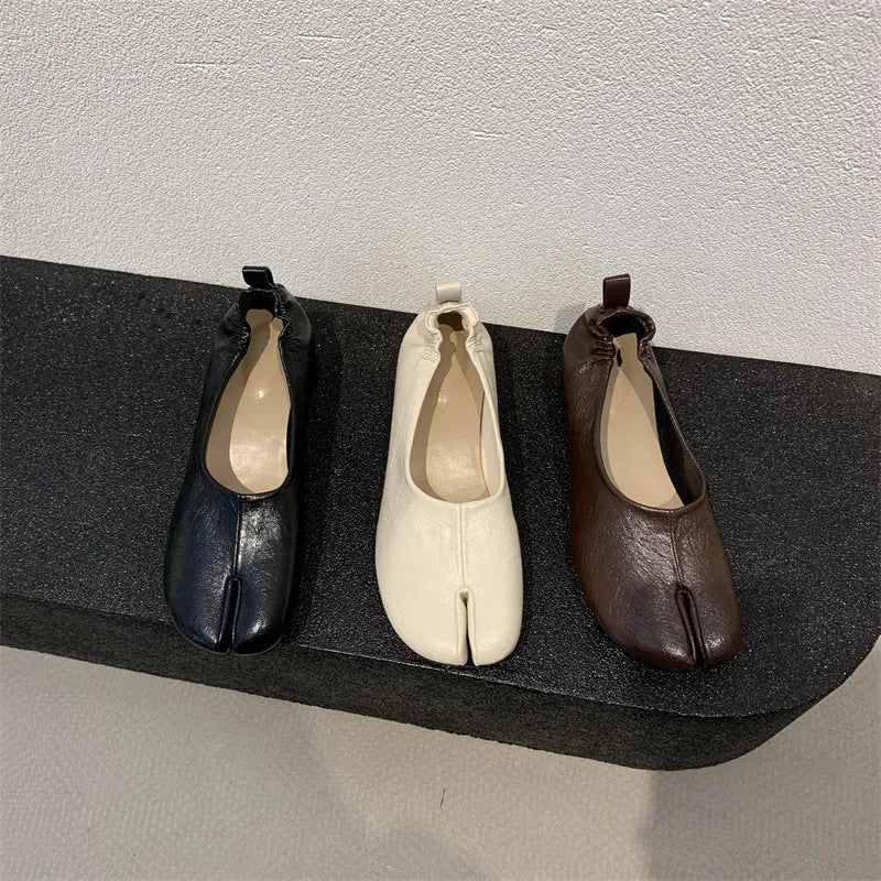 Women's round toe pumps with a split toe horseshoe design and a chunky low heel.