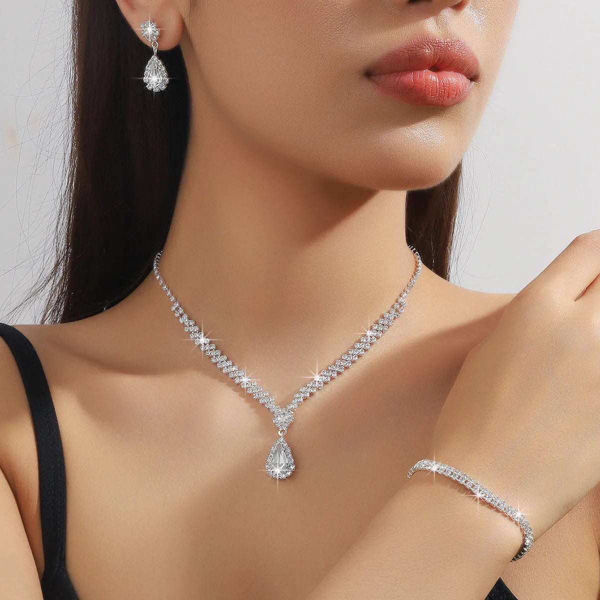 Rhinestone claw chain necklace and earrings set with water drop shape, available in multiple colours for women.