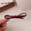 Wine red leather bow barrettes hair clips with structured design