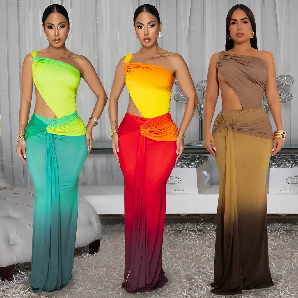 A woman wearing a long gradient colour dress with a cross-shoulder sleeveless design and a high waist.