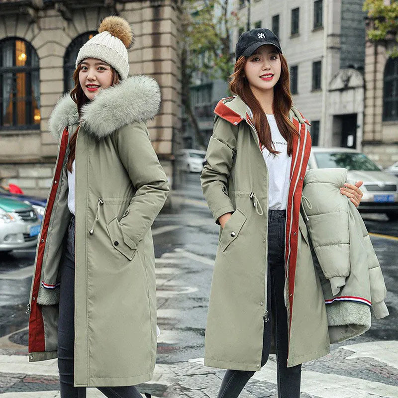 Women's long white padded trench coat with down cotton filler and fleece construction on a hanger.