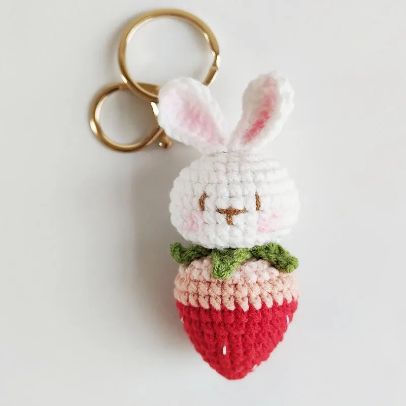 White hand-woven wire pendant with rabbit and strawberry design on a key fitting.