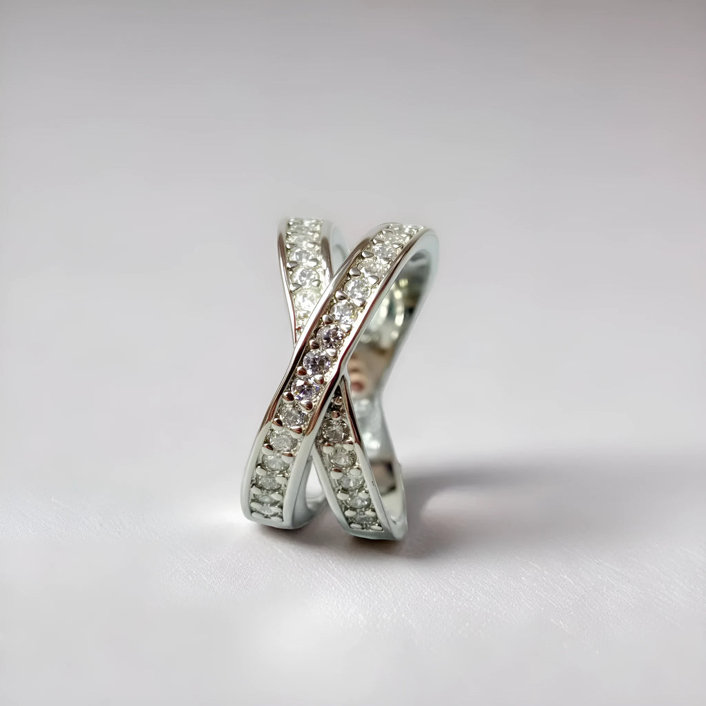 Copper metal cross ring with micro-inlaid zircon stones in silver electroplated finish showing geometric heart-shaped design