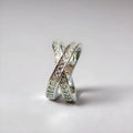 Copper metal cross ring with micro-inlaid zircon stones in silver electroplated finish showing geometric heart-shaped design