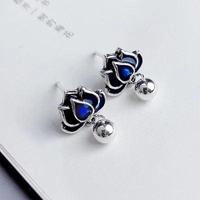 Blue lotus flower alloy earrings with seedpod and tassel design, silver plated, shown at actual size of 1.2cm wide.