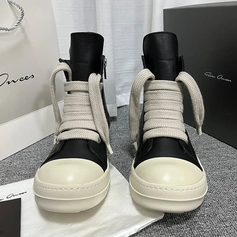 Genuine leather high-top unisex sneakers with side zipper in black, shown on a neutral background.