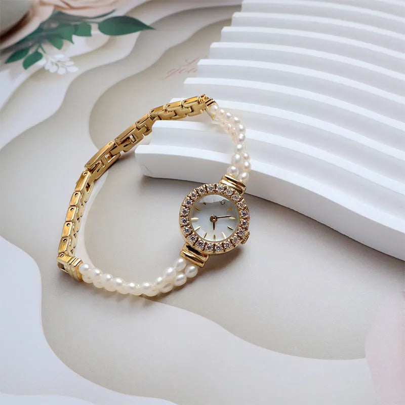 Women's light gold bracelet watch with freshwater pearls, round dial and stainless steel strap