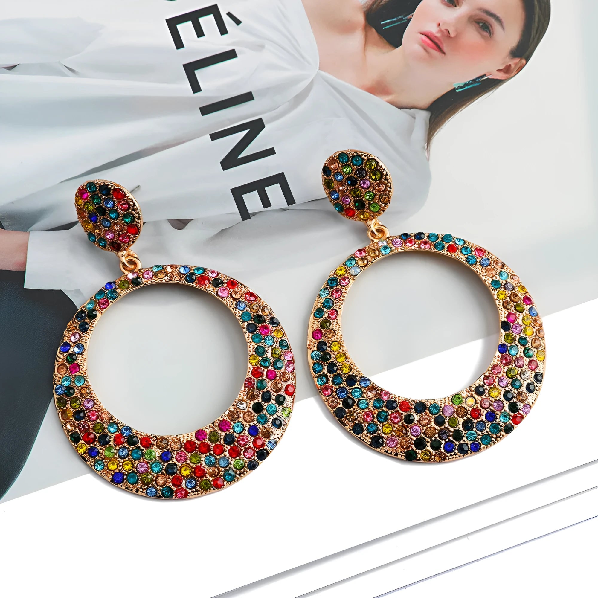 A pair of large round colourful alloy pendant earrings with a cartoon style on a white background.