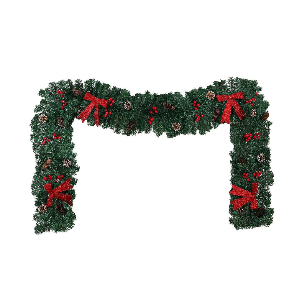 Christmas rattan wreath decoration with pine cones and red bow on green background