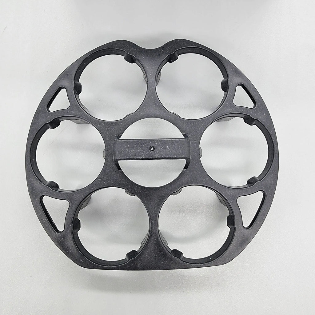 Modern black plastic egg holder tray measuring 13.8 by 12.6 by 5.7 centimetres on a kitchen counter.
