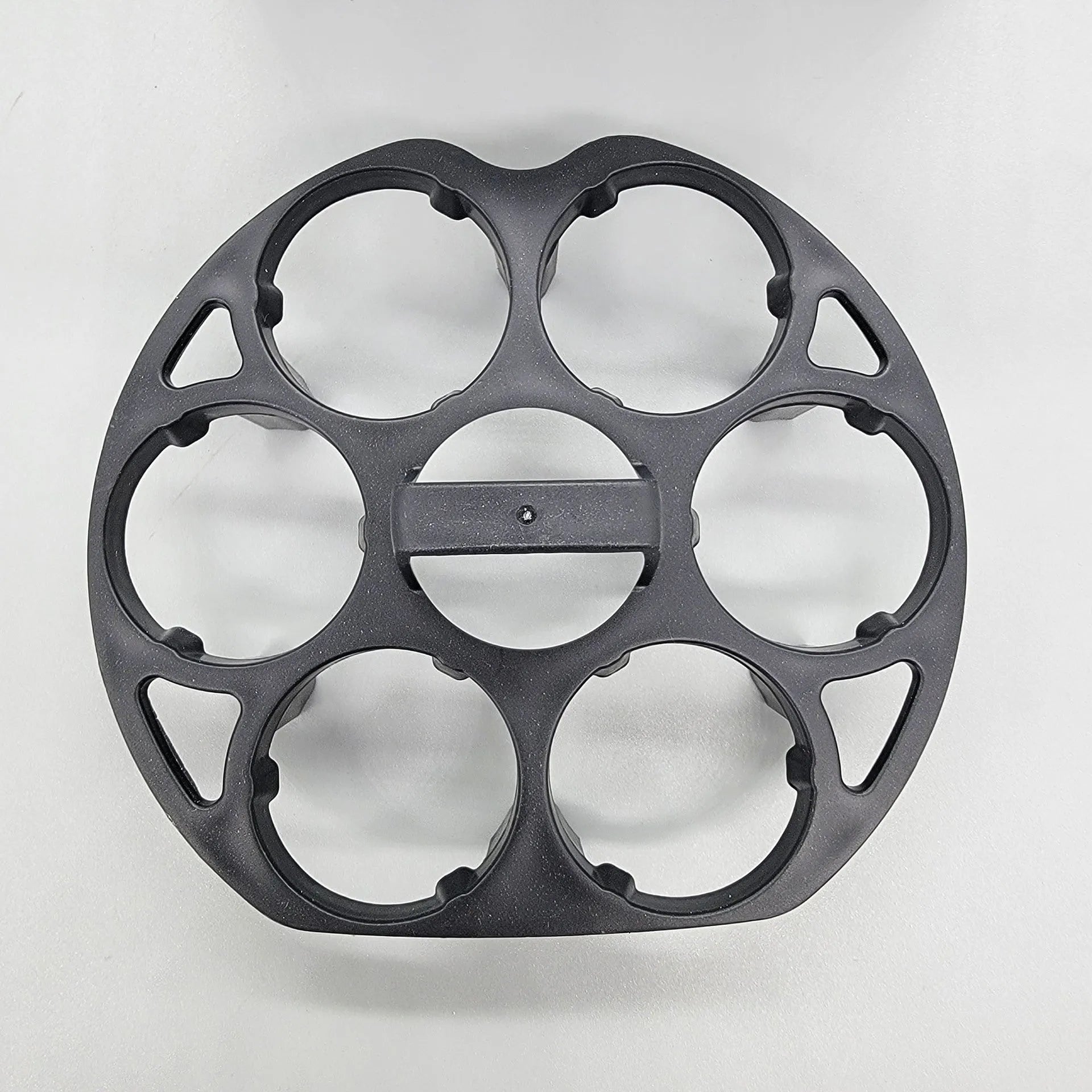 Modern black plastic egg holder tray measuring 13.8 by 12.6 by 5.7 centimetres on a kitchen counter.
