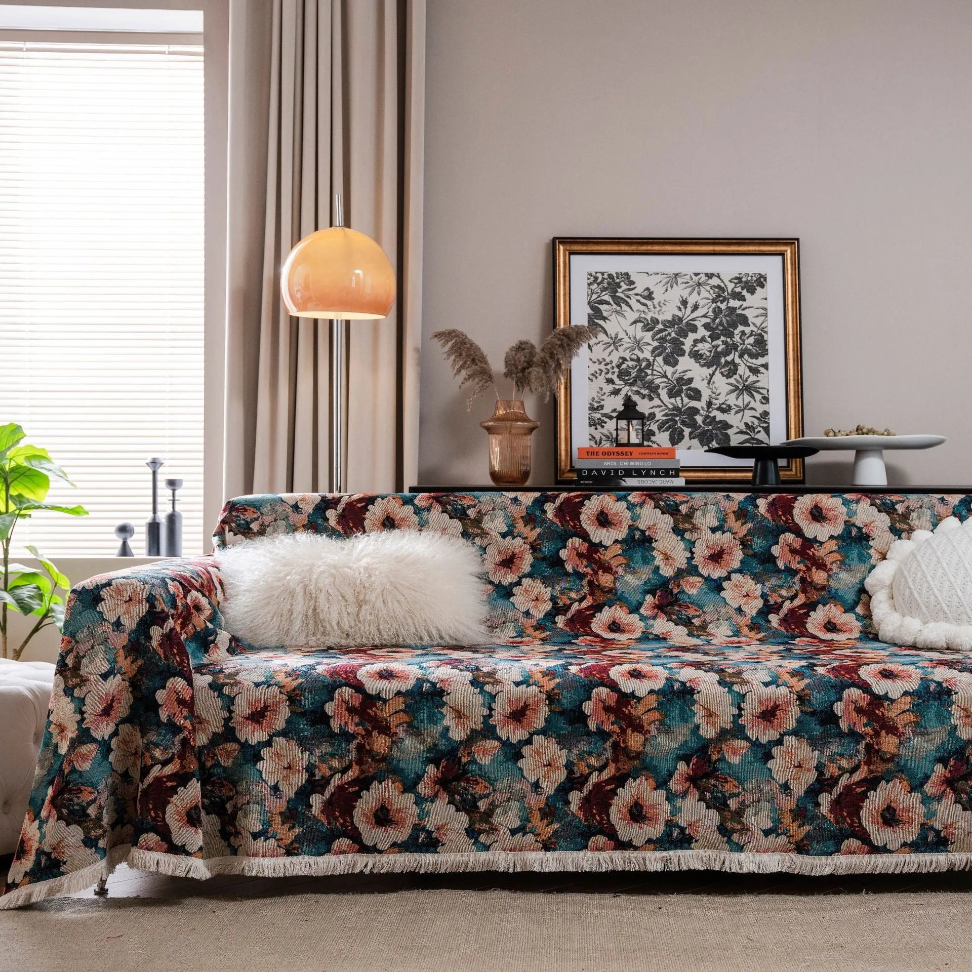 American country style jacquard patterned sofa cover in a green colourway draped over a sofa.