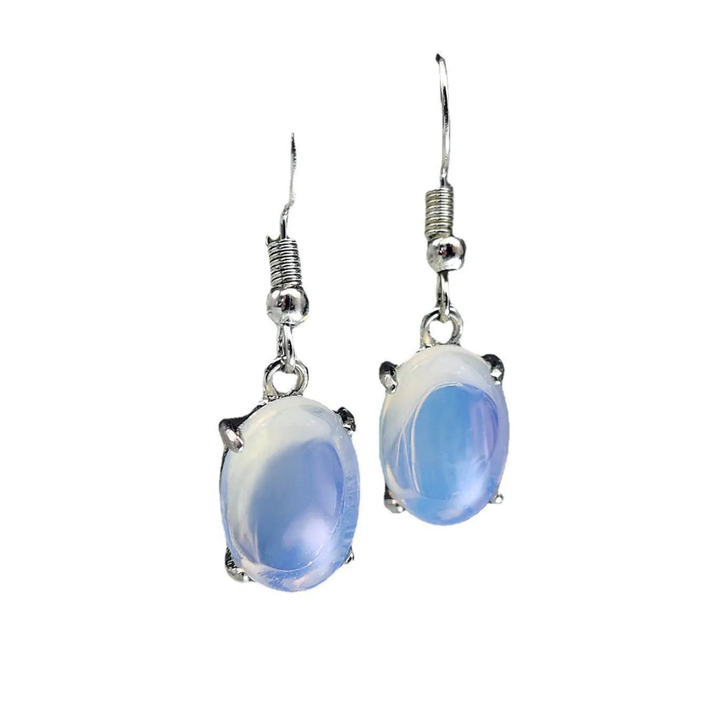 A pair of retro opal earrings with a moonstone eardrop and cross design in electroplated alloy.
