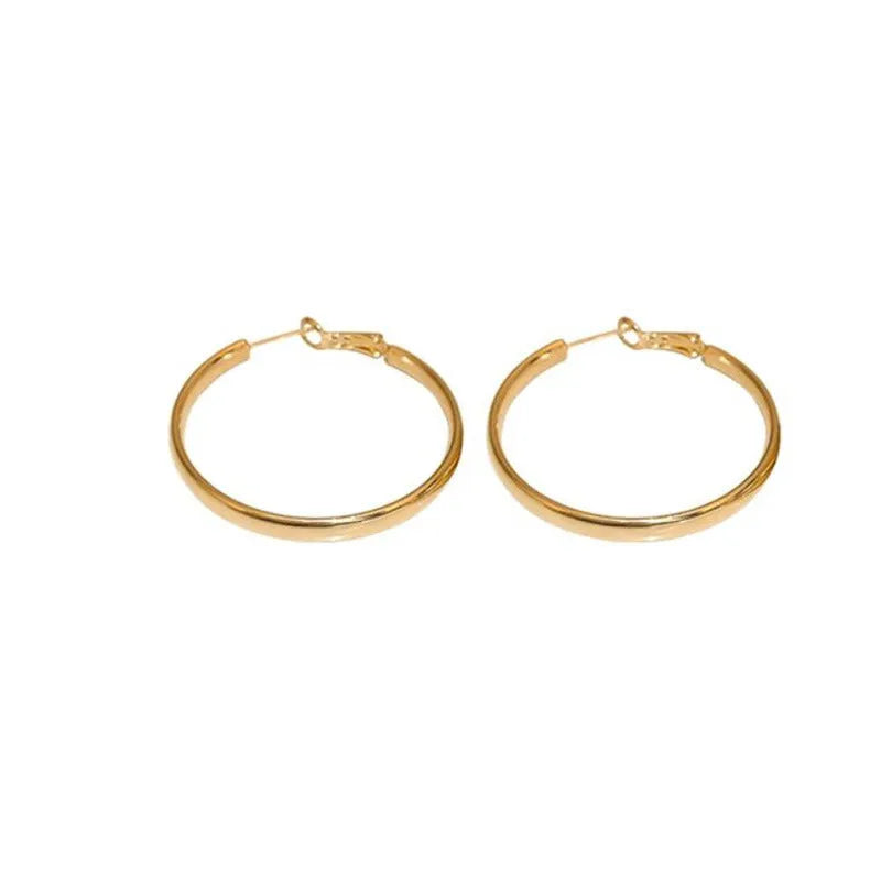 A pair of large gold-coloured circular metal earrings with a 40mm diameter on a white background.