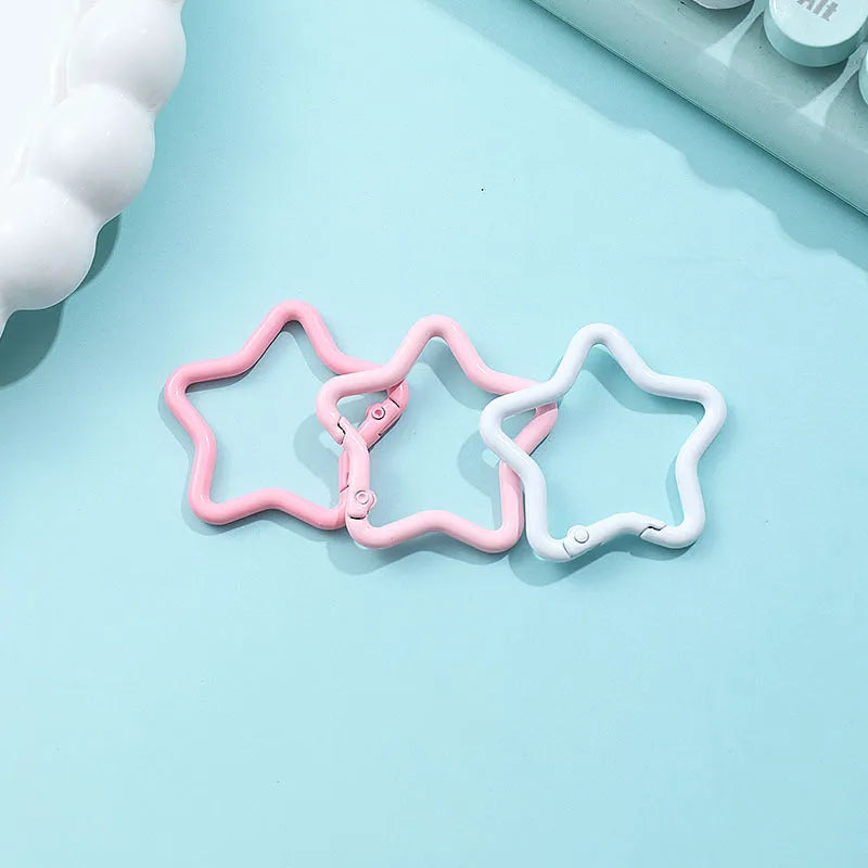 Zinc alloy five-pointed star keychain charm in multiple colour options on a keyring.