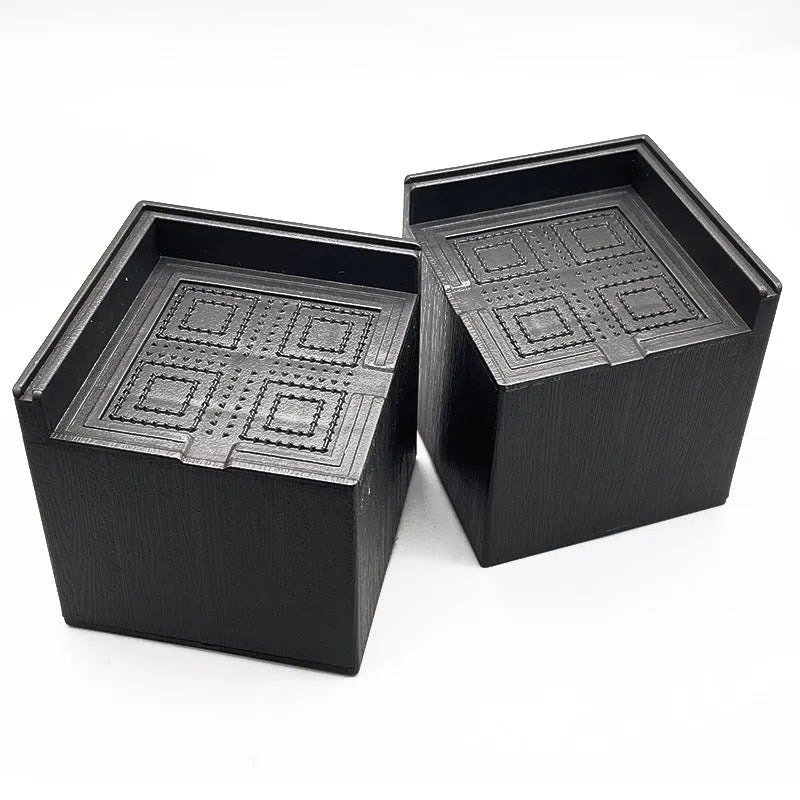Four black thickened plastic bed foot mats for raising sofa and furniture height.