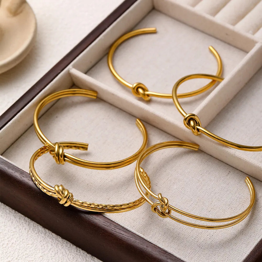 Stainless steel 18K gold plated knotted open double-layer bracelet in gold (SZ46G) on a white background