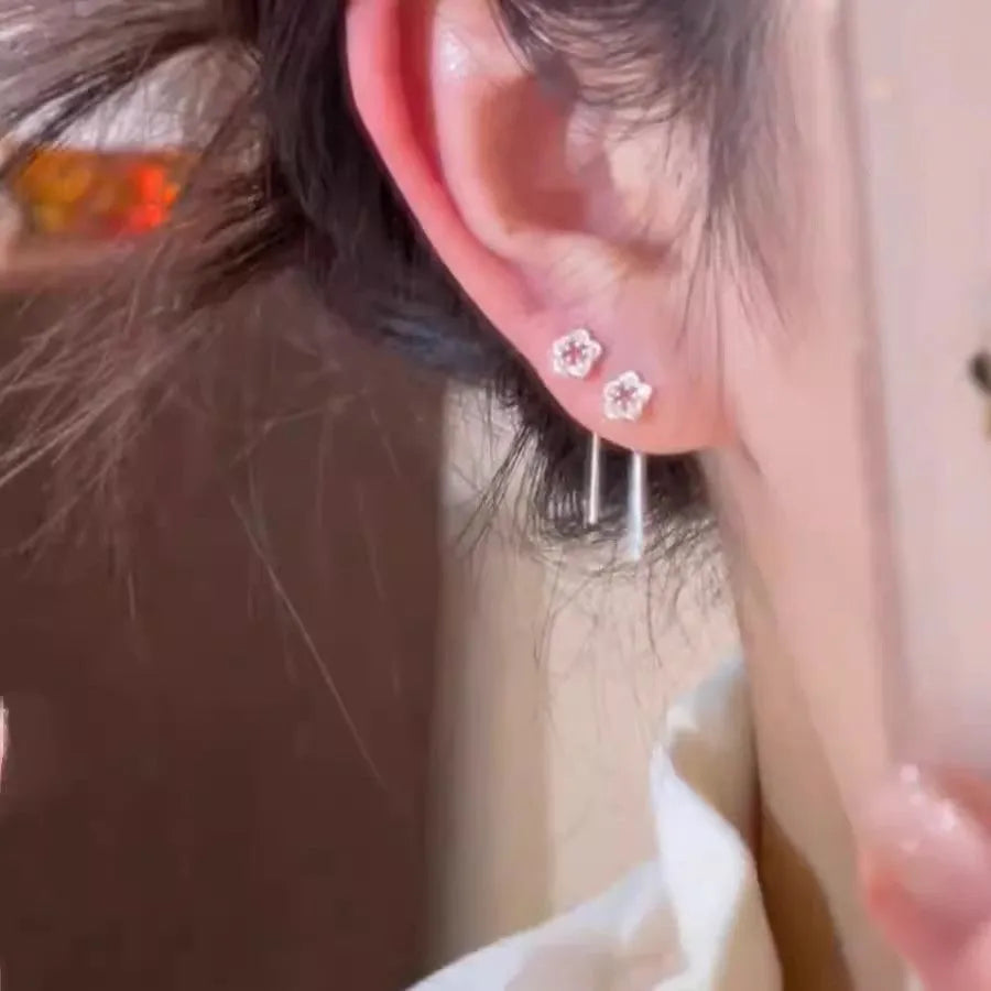 Sterling silver hollow flower drop earrings with petal design and hook fastening